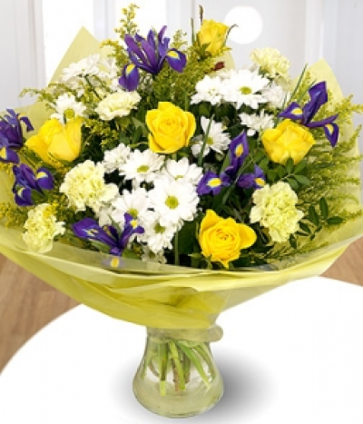 Beginnings - A bright, fresh, yellow, green and white bouquet. Featuring Roses, Irises, Carnations, Chrysanthemums, Pistache and Solidago.