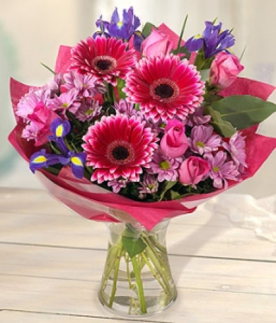 Welcome - A charming pink and lilac bouquet featuring pink Gerberas, Roses and Chyrsanthemums, perfectly married with Irises.