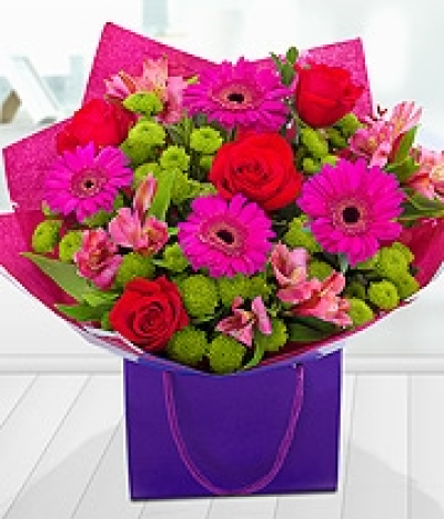 Celebration Bouquet - Cerise Alstoemeria and deep red Roses have been expertly combined with luscious green Santini and Eucalyptus leaves.