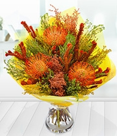 Red Sky - Fiery orange Leucoperumum blooms are neatly nestled in amongst an array of wild Cape Flora foliage creating this stunning autumnal floral arrangement.