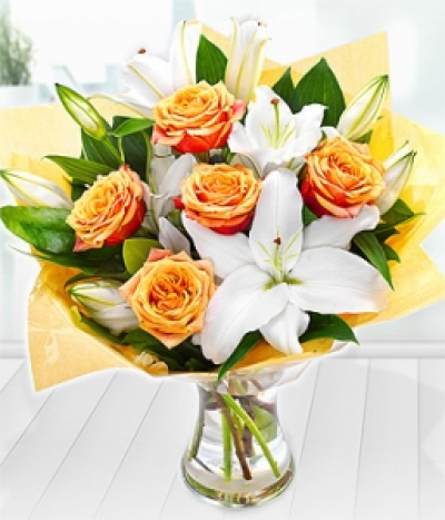 Festival - White Oriental Lilies and delectable Cherry Brandy Roses create this simply sumptuous autumnal bouquet.