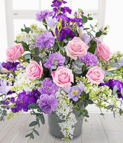 Lady-In-Waiting - An enchanting flower display exquisitely presented, featuring pink Roses, white Lilacs, purple Stocks with lilac Carnations and delicately fragrant Freesias.