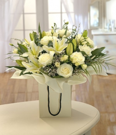 Stylistic - A gorgeous selection of flowers featuring white Roses and fragrant Lilies delivered in a stylish gift bag. This stunning hand-tied will certainly create the wow factor.