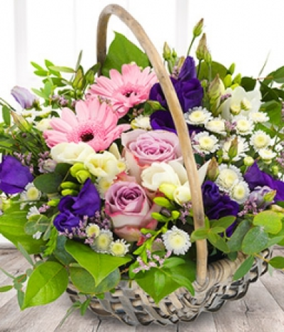 Sweet Basket - A vintage basket of lilac roses, pink gerbera, white freesia, white chrysanthemums and purple lisianthus. Scent with love for any occasion.