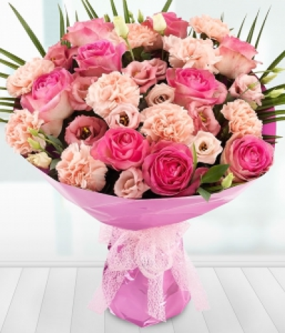 Angelic - A divine collection of heavenly pink Roses, Lisianthus and Carnation blooms presented lovingly in pink with a bow.