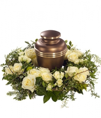 White Urn Wreath - An elegant white crescent creates a beautiful focal point for an urn. White Hydrangea and Calla Lilies are the feature with spray Roses and green spray Chrysanthemums. Urn not included.