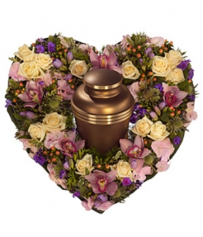Urn Heart - A delicately fragrant heart shaped urn wreath featuring cream Roses, purple Phlox and Freesia, pink Hypericum, Cymbidium Orchids and Hydrangea with a touch of white Eryngium. Urn not included.