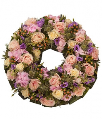 Pastel Wreath - A pretty pastel wreath. Pink and cream Roses, pink Hydrangea and Hypericum are mixed with purple Lisianthus and white Eryngium.