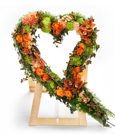 Orange Swinging Heart - A contemporary orange swinging heart design featuring Roses, Calla Lilies, Celosia, Gerbera, Chrysanthemums and Carnations.