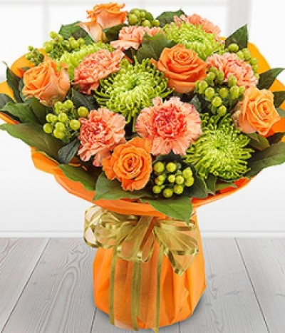 Dawn Til Dusk - A simply sumptuous arrangement of orange Roses & Carnations mixed with luscious green Chrysanthemums and Hypericum Berries. Absolutely stunning.