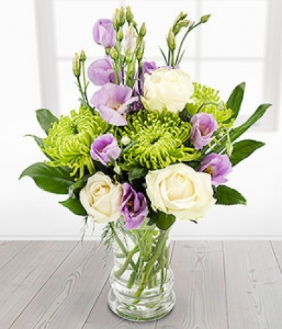 Candle Light - Lovely lilac Lisianthus blooms with glorious green Chrysanthemums and creamy white Roses. Professionally arranged in a clear glass vase and ready to display.