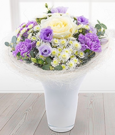 Mellow Mauve - A delicate lilac and white vase arrangement. Roses and Germinis married with lilac Lisanthus blooms are neatly nestled in amongst white Spray Chrysanthemums and lilac Carnations.
