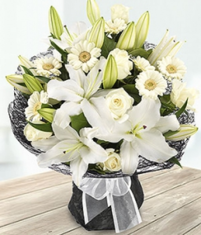 Ebony and Ivory - A stunning pure white Rose, Lily and Germini aqua pack bouquet exquisitely presented.