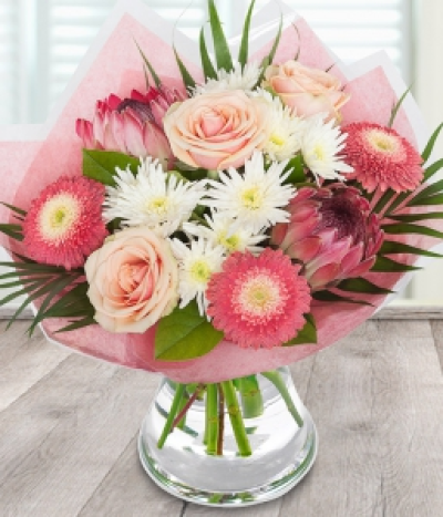 Protea Bouquet - Exotic protea sit alongside dahlia and peach roses, decorated with striking chrysanthemums in this truly tropical bouquet.