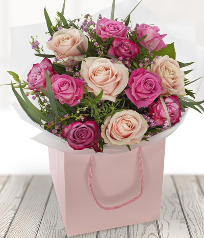 Dozen Pink Diamonds - 12 pink roses with stunning foliage, lovingly delivered by a highly talented local florist, ready to be displayed in a handy gift bag.