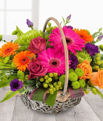 Fruits of Love - An orchestra of colour in one fabulous flower basket arrangement. Cerise Roses and Gerberas, orange Roses and Germini, purple Lisianthus married with Green Chrysanthemums.