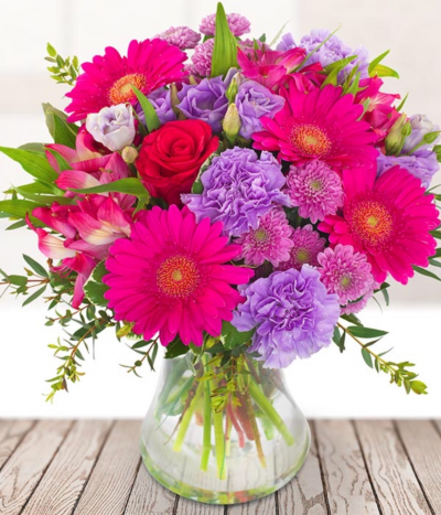 Home Sweet Home - Bring a little sunshine into their new home with a stunning bouquet packed full of bright flowers, with popping pink germini, purple carnations and roses.