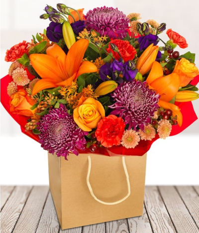 Warm Vibrant Love - A truly sensational bouquet full of deep and intense colours that evoke the feeling of hazy late summer days. Orange lily complements purple blooms and roses to create the perfect gift for any occasion.