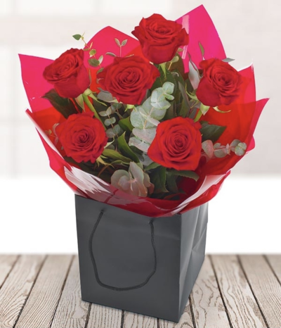 Six Red Roses - A classic bouquet of six luscious red roses, finished off perfectly with elegant foliage. This romantic hand-tied bouquet is the only way to show your love to that special someone whatever the occasion.